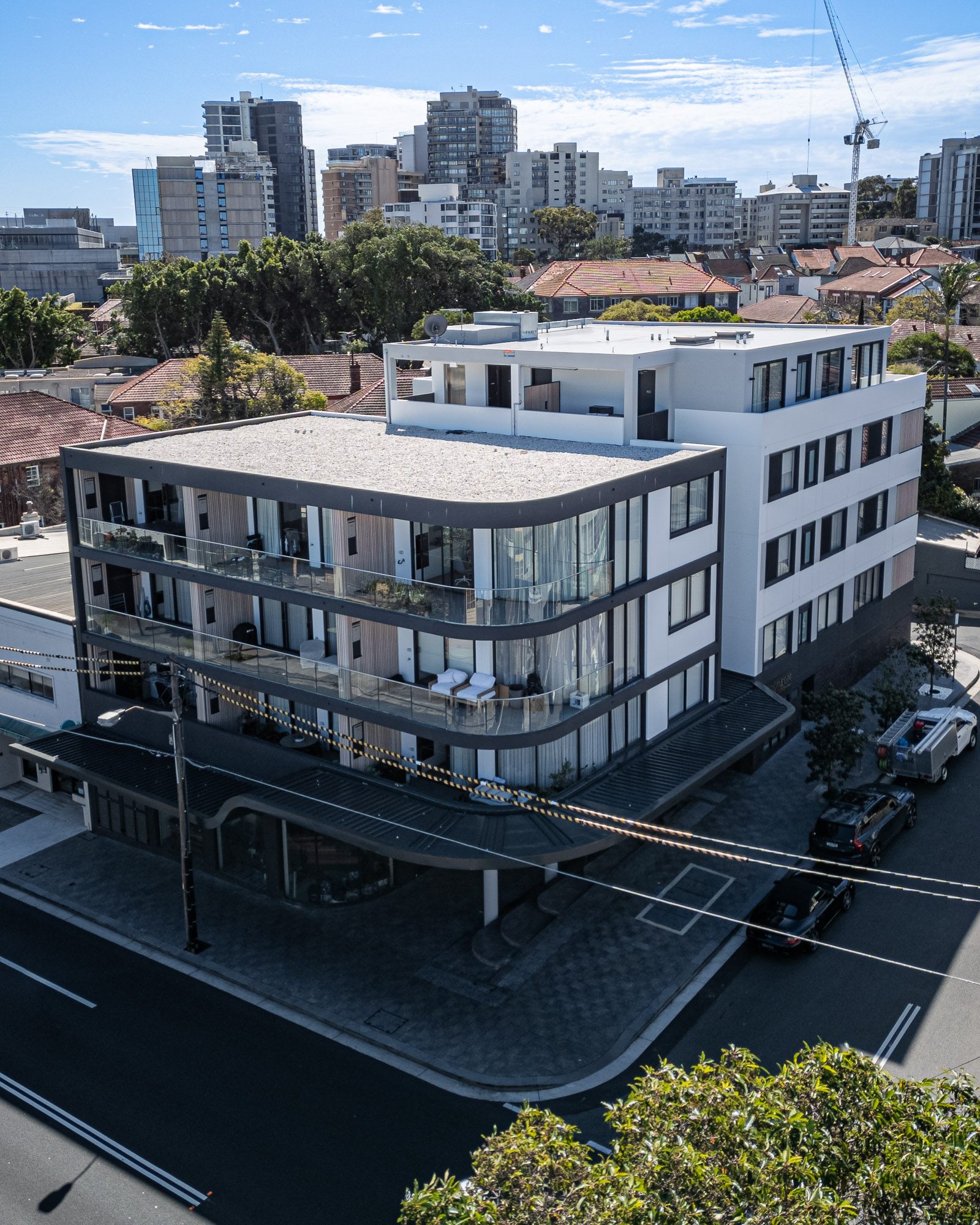 Modern Australian urban mixed-use complex with ground-floor retail and multiple residential levels