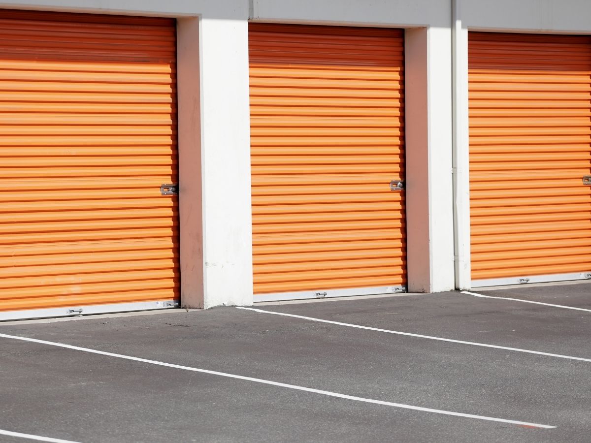 Rows of drive-up self-storage units with roller doors and vehicle access at an Australian storage facility